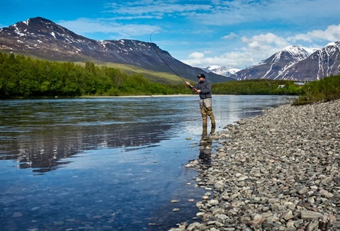 man fishing on river